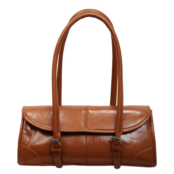 Brown leather handbag with a strap on a white background