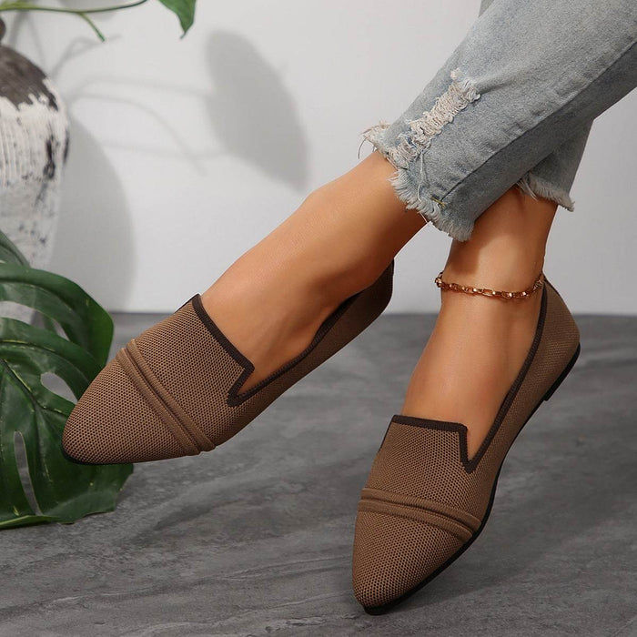Brown mesh shoes worn with rolled-up jeans on a neutral background