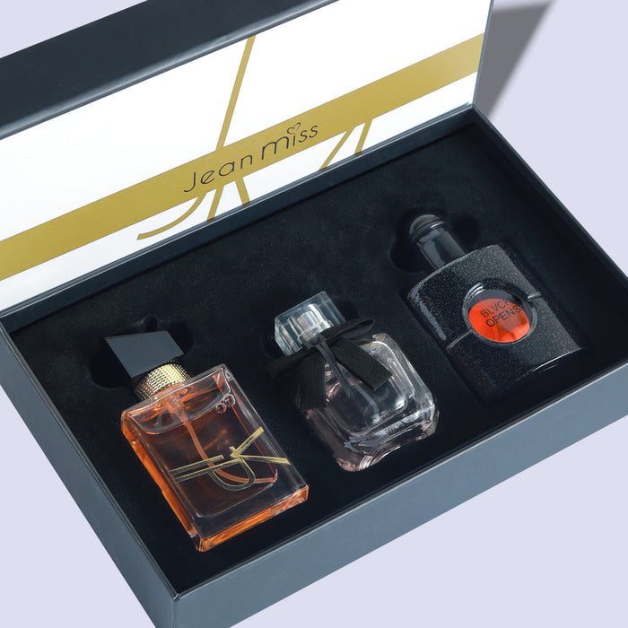 Three perfume bottles in a display case with 'Jean Miss' branding.