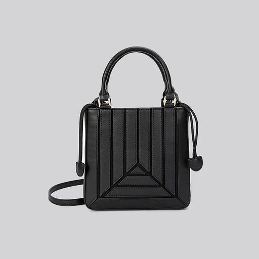 Black handbag with geometric design on a light gray background