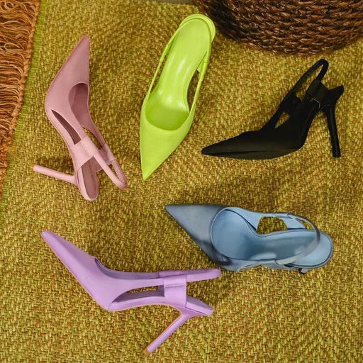 Five colorful high-heeled shoes on a textured surface