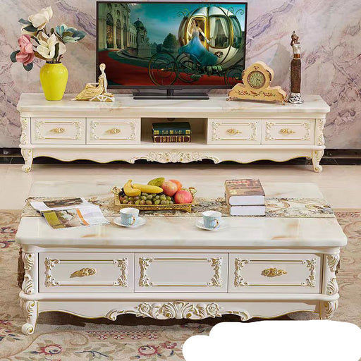 Decorative TV stand with a television, flowers, and decorative items against a marble wall.