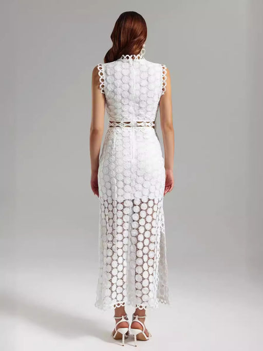 Woman wearing a white lace dress against a gray background