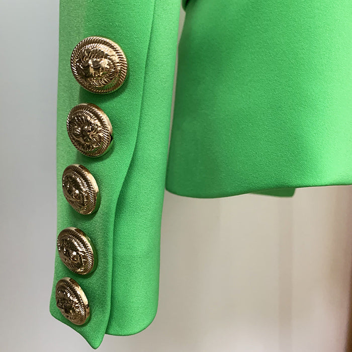 Green jacket with gold buttons on a neutral background