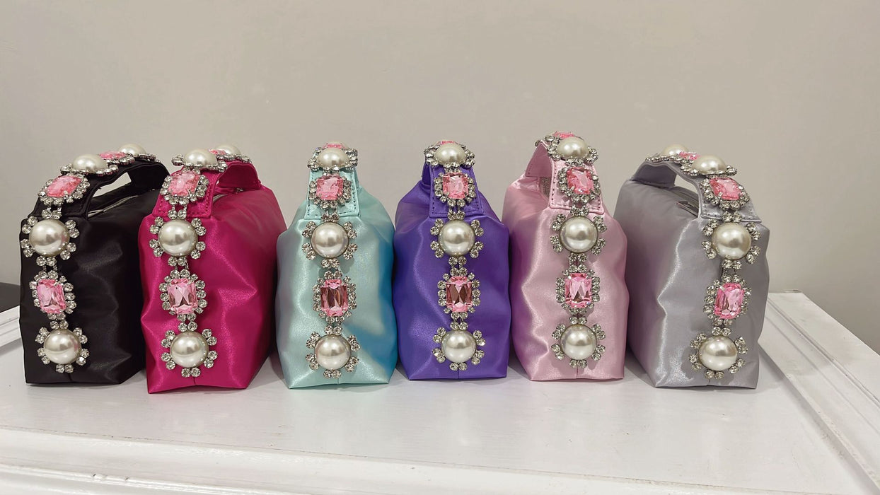 Set of decorative boxes with pearl and gem embellishments on a white surface.