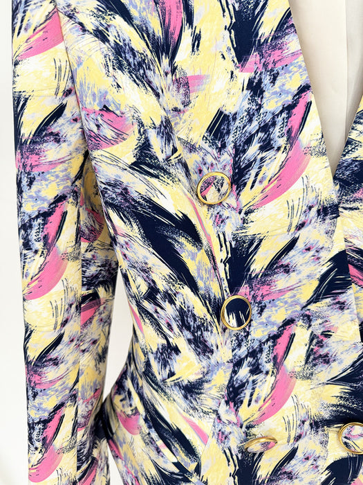 Colorful abstract patterned fabric with pink, yellow, and black colors.
