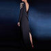Black evening gown with gold embellishments on a dark blue background