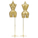 Two gold mannequin torsos on stands against a white background