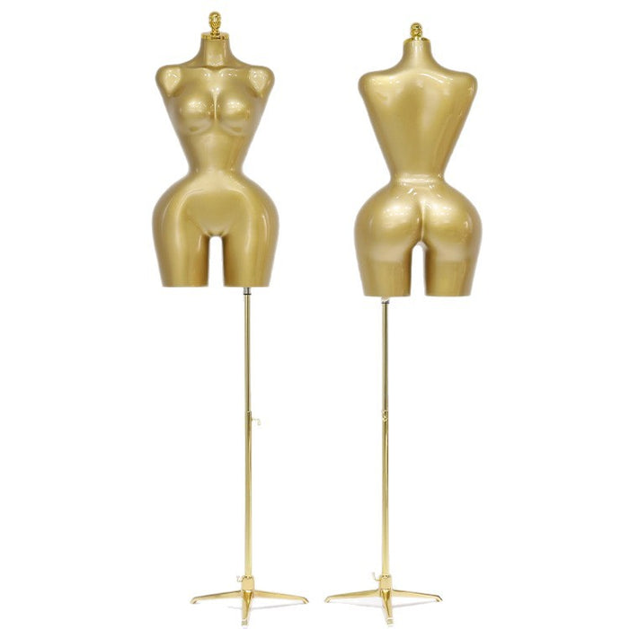 Two gold mannequin torsos on stands against a white background