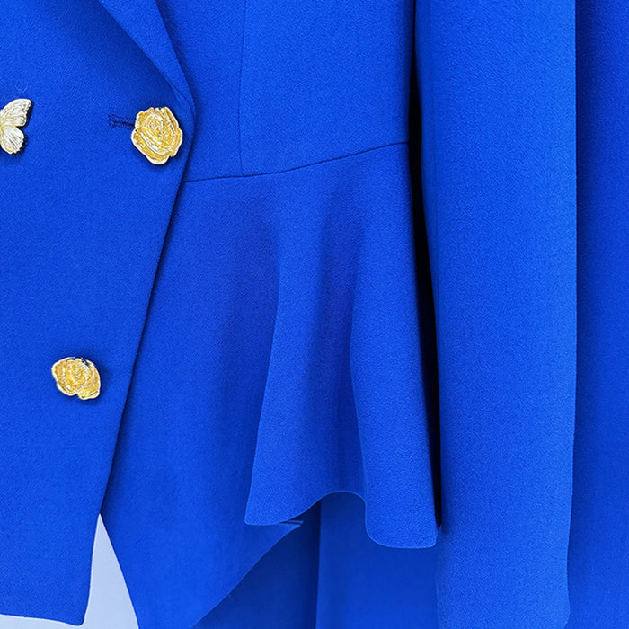 Close-up of a blue coat with gold buttons on a white background