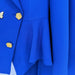 Close-up of a blue coat with gold buttons on a white background