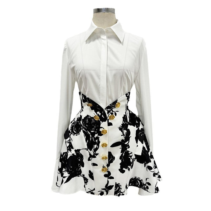 White shirt with black floral pattern and gold buttons on a mannequin against a white background