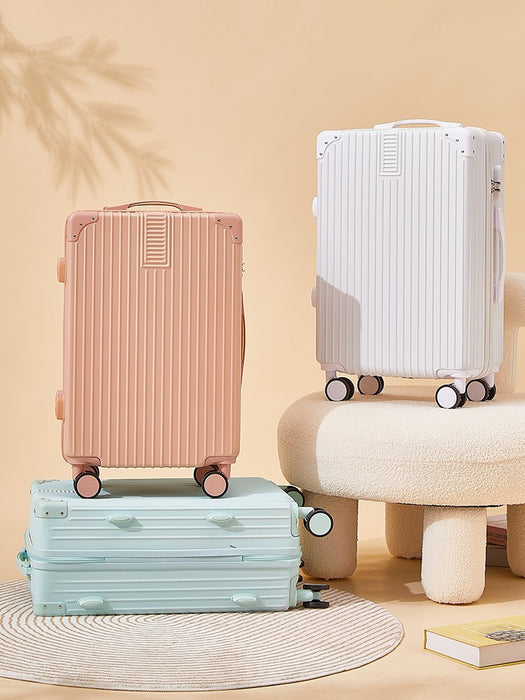 Three suitcases in pink, white, and green on a beige background