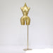 Gold mannequin torso on a stand against a white background
