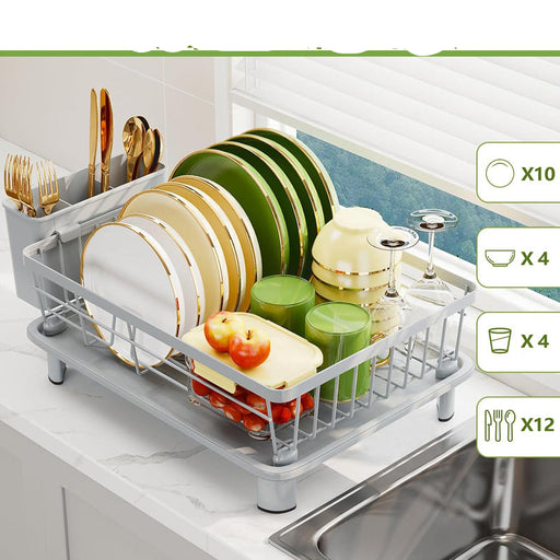 Dish drying rack with plates, bowls, and glasses on a kitchen counter.