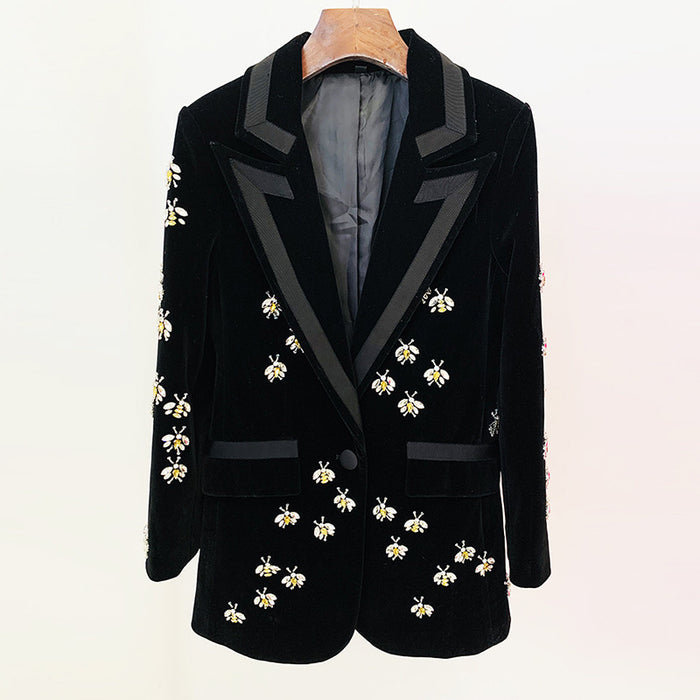 Black velvet blazer with floral embroidery on a mannequin against a white background