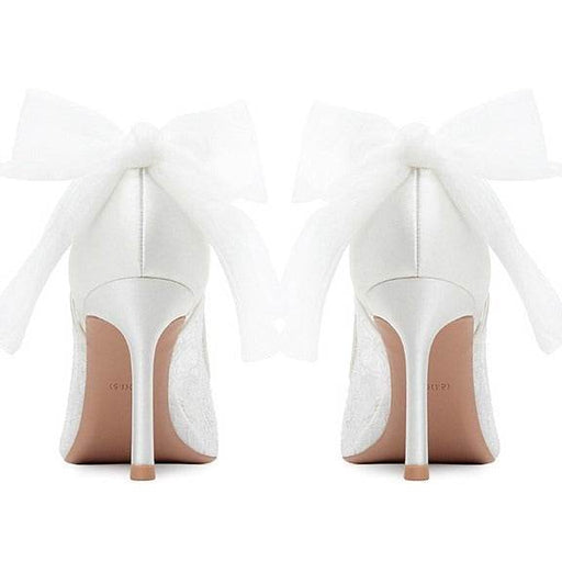 White high-heeled shoes with a visible brand name on a white background