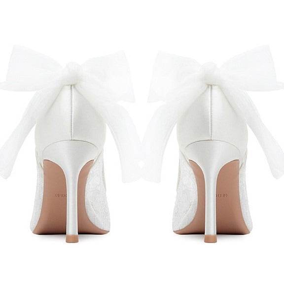 White high-heeled shoes with a visible brand name on a white background