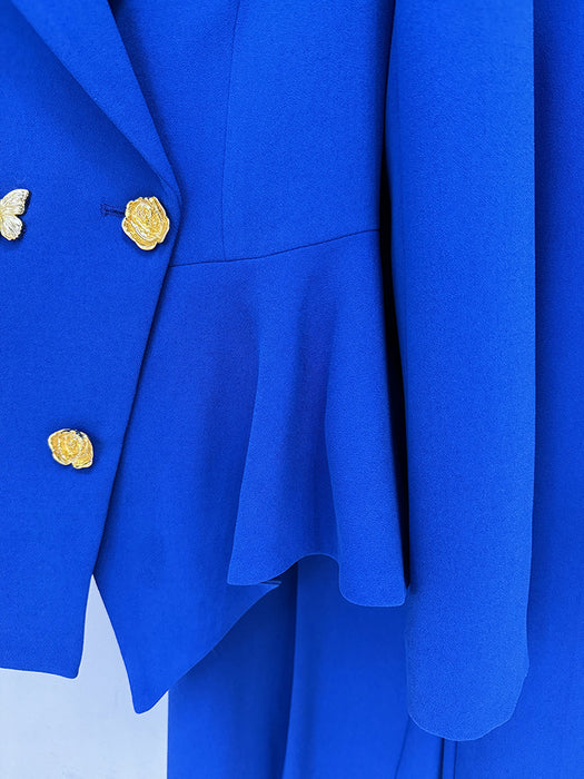 Close-up of a blue coat with gold buttons on a white background