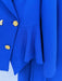 Close-up of a blue coat with gold buttons on a white background
