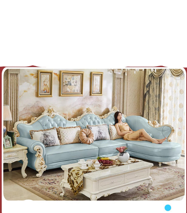 Luxury living room with a blue sofa, woman lounging, and decorative elements.