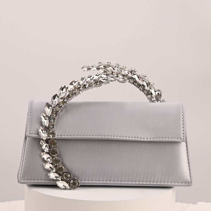 Gray handbag with a decorative chain handle on a light gray background