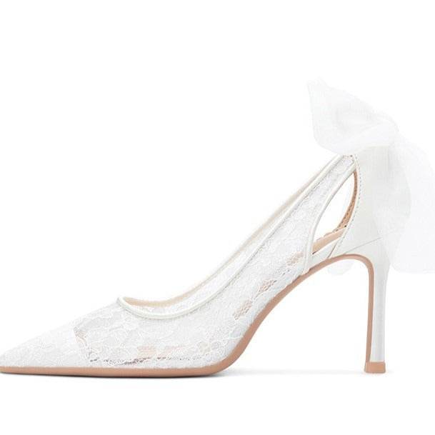 White lace high-heeled shoes on a white background