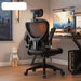 Black office chair in a room with a desk and computer setup