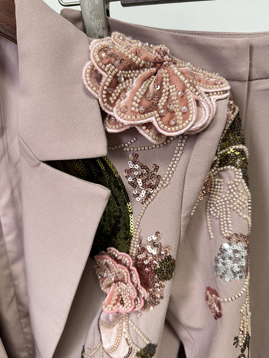 Close-up of a beige coat with floral embellishments and sequins.