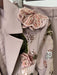 Close-up of a beige coat with floral embellishments and sequins.
