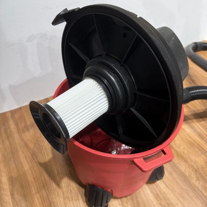 Black and white filter inside a red bucket on a wooden surface
