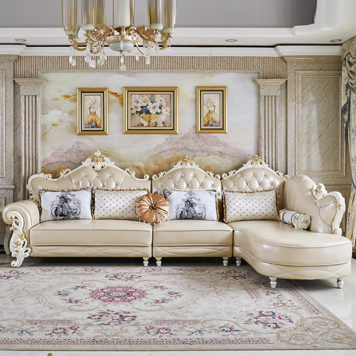 Luxurious living room with a cream-colored sofa, decorative pillows, and a chandelier.