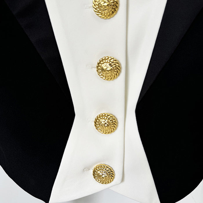 Close-up of a black and white jacket with gold buttons