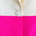 Close-up of a jacket with a white button on a pink and white background