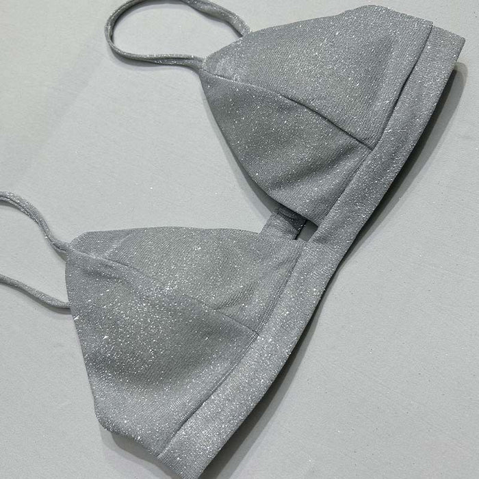 Silver glitter bikini set on a light gray background