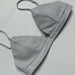 Silver glitter bikini set on a light gray background