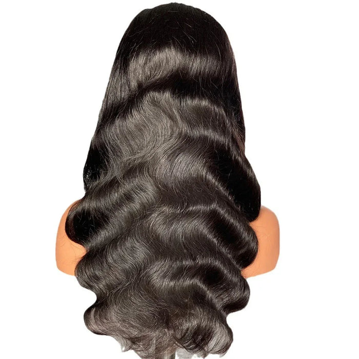 Black wavy hair extension on a mannequin head against a white background