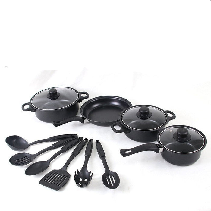 Set of black cookware with lids and kitchen utensils on a white background