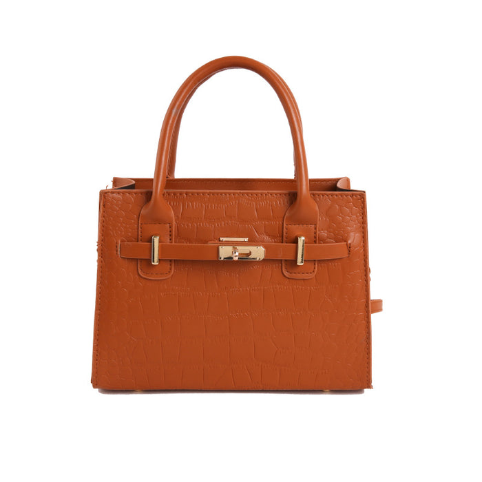 A structured cognac brown crocodile-embossed leather handbag with double top handles and gold-tone hardware, shown against a plain white background.