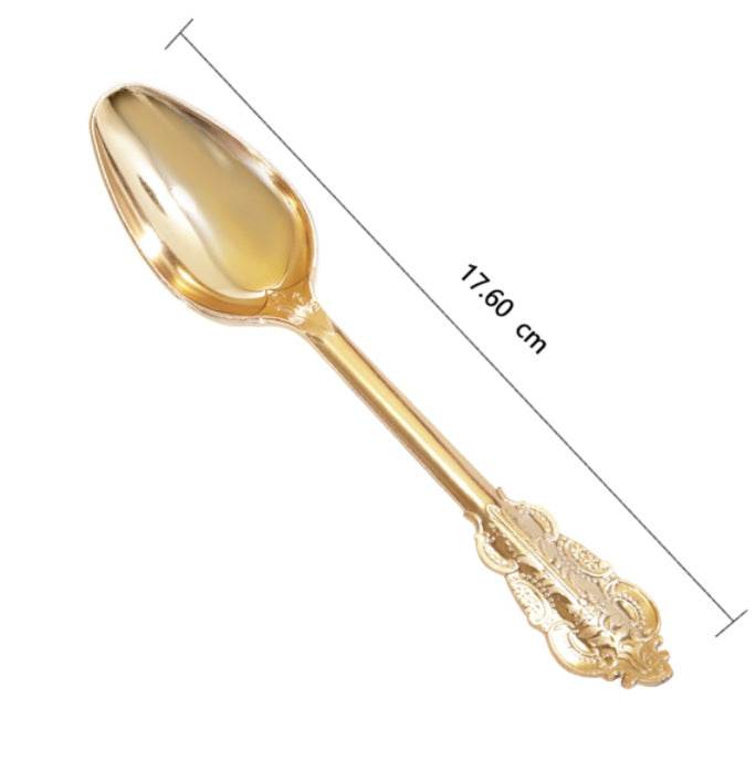 Gold spoon with decorative handle and measurement details on a white background