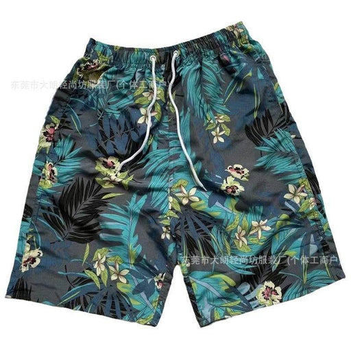 Tropical leaf patterned shorts on a white background