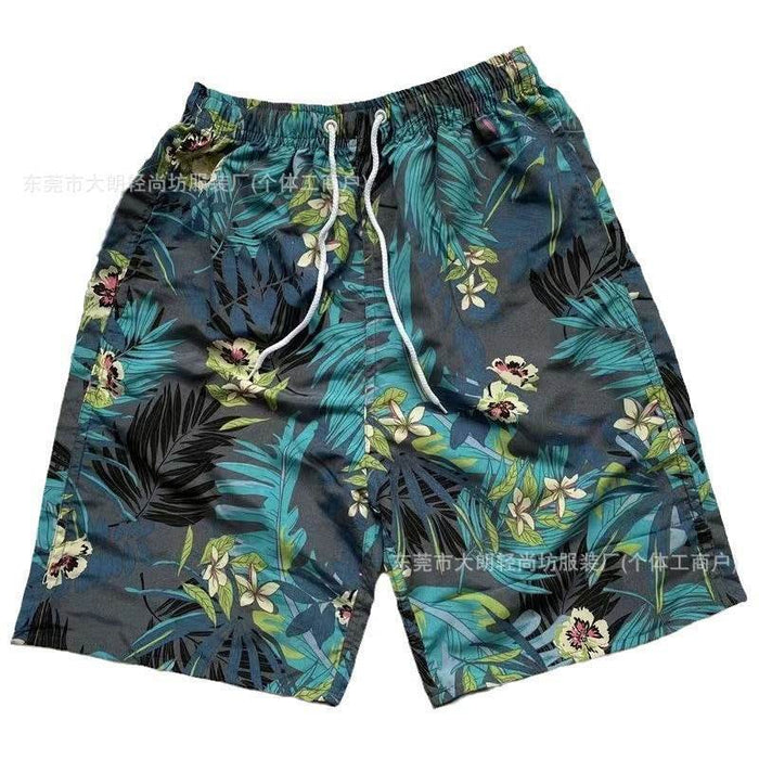 Tropical leaf patterned shorts on a white background
