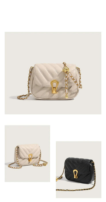 Beige handbag with gold chain and clasp on a light gray background