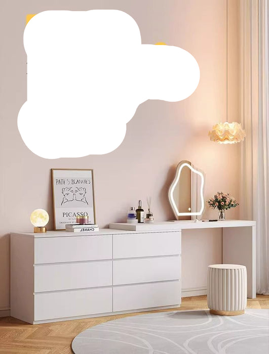 White vanity table with mirror and decorative items in a room setting.