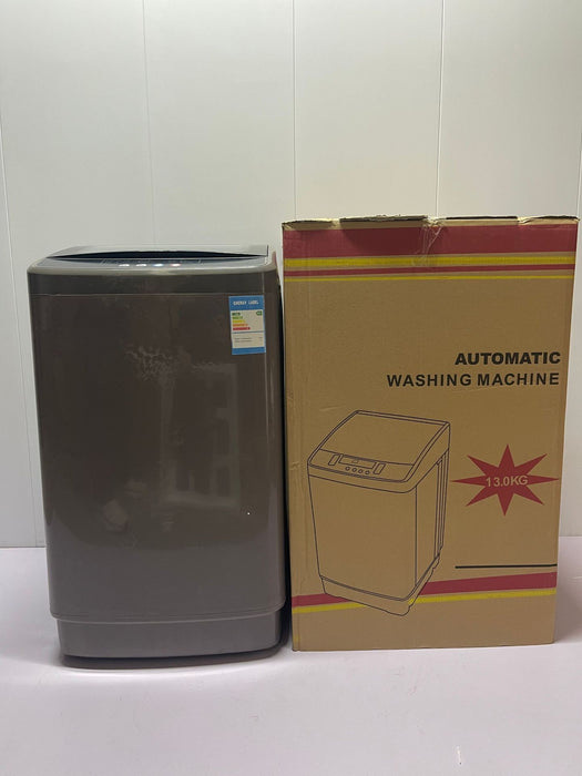 Gray washing machine next to its packaging box on a white background