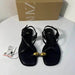 Black sandals with gold accents and Zara box on a white surface