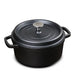 Black cast iron cookware pot with lid on a white background