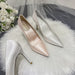Pair of high-heeled shoes on a fur surface with flowers in the background