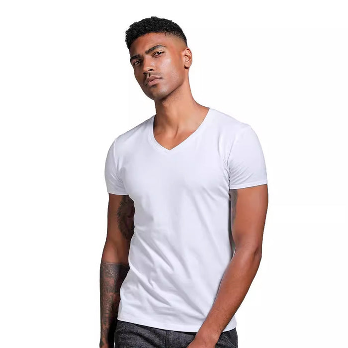 Man wearing a plain white t-shirt against a white background