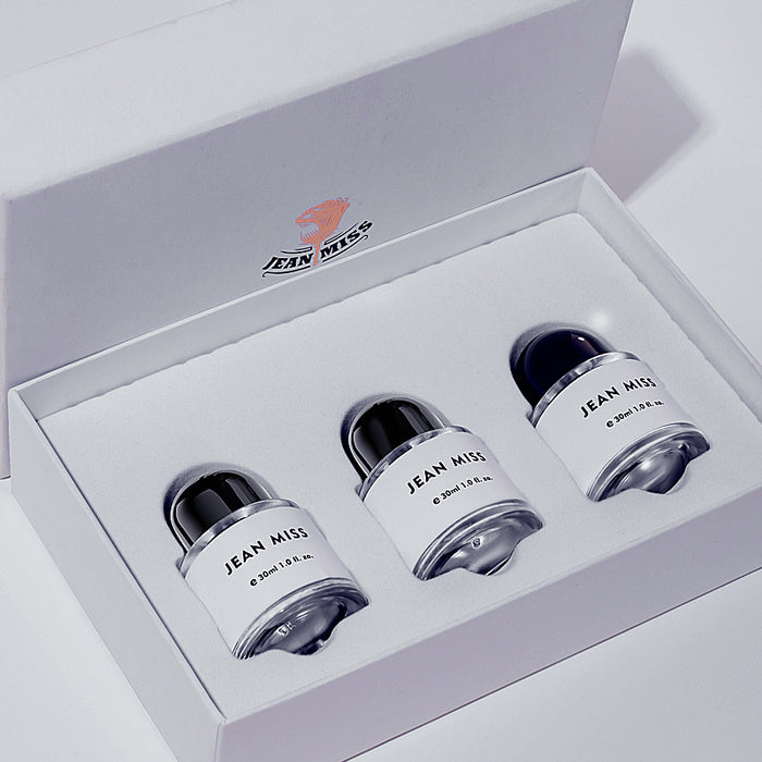 Set of three 'Jean Miss' perfume bottles in a box on a white background